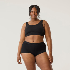 Front close up view of model wearing organic cotton essentials women's boyshort 2 pack in color black.