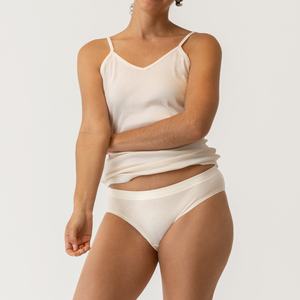 Close up front view of model wearing organic cotton essentials women's bikini 2 pak in color natural.