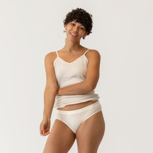 Close up front view of model wearing organic cotton essentials women's bikini 2 pak in color natural.