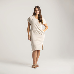 Side full body view of model wearing organic cotton kaftan dress in pearl.