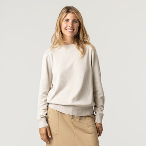 Front view of model wearing organic cotton classic crew sweater in color pearl.