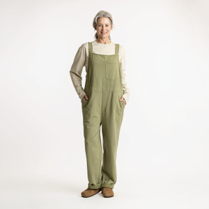 Full body front view of model wearing organic cotton overalls in color bay.