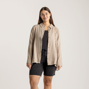 Close up front view of model wearing organic cotton button down shirt in color putty.