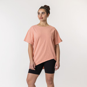 Full body front view of model wearing organic cotton French tuck tee in color blush.