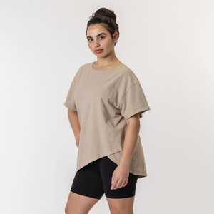 Close up front view of model wearing organic cotton French tuck tee in color putty.