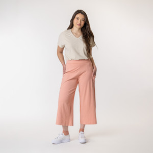 Full body view of model wearing organic cotton gaucho pant in color blush.
