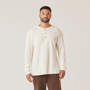 Close up front view of model wearing organic cotton waffle henley in color natural.