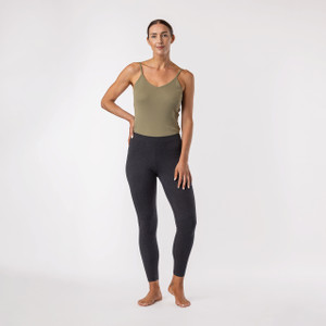 Model wearing heather grey color organic cotton ankle base layer leggings.
