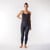 Full body front view of model wearing heather grey solid color organic cotton fleece leggings.
