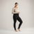 Model wearing black solid color organic cotton fleece leggings.