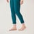 Close up front view of bottom half of model wearing teal color organic cotton fleece leggings.