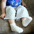 Baby wearing Natural white solid color organic cotton baby anklet socks.