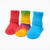 Red solid color, tie-dyed colorful, and bright blue solid color organic cotton baby anklet socks. Pack of three.