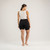 Full body back view of model wearing organic cotton blackout pocket leggings short.