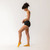 Side full body view of model wearing organic cotton essentials - women's boyshort 2 pack in color black.