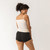 Back close up view of model wearing organic cotton essentials - women's boyshort 2 pack in color black.