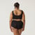Back close up view of model wearing organic cotton essentials women's boyshort 2 pack in color black.