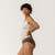 Close up side view of model wearing organic cotton essentials women's bikini 2 pak in color sable.