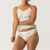 Close up front view of model wearing organic cotton essentials women's bikini 2 pak in color natural.