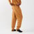 Side view of model wearing Unisex Fleece Jogger in tawny color featuring back pocket