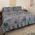 Moon rise block print cotton duvet and sham set shown on a bed.