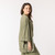 Side view of model wearing organic cotton kimono in bay.