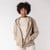 Front view of model wearing organic cotton hooded cardigan in putty with hand in pocket.
