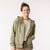 Front view of model wearing organic cotton hooded cardigan in bay with hand in pocket.