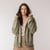 Front view of model wearing organic cotton hooded cardigan in bay with hood pulled up.