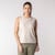Front view of model wearing organic cotton sleeveless tee in pearl.