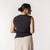 Back view of model wearing organic cotton sleeveless tee in pepper.