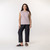 Front view of model wearing organic cotton sleeveless tee in lavender.