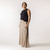 Full body front view of model wearing organic cotton maxi skirt in putty.