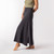 Close up side view of model wearing organic cotton maxi skirt in pepper.