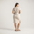 Front full body view of model wearing organic cotton kaftan dress in pearl.