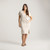 Side full body view of model wearing organic cotton kaftan dress in pearl.