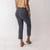 Back view of model wearing organic cotton flare pant in pepper.