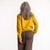 Back view of model wearing organic cotton classic crew sweater in color gold