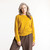 Front view of model wearing organic cotton classic crew sweater in color gold