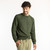 Front view of model wearing organic cotton classic crew sweater in color pine