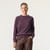 Front view of model wearing organic cotton classic crew sweater in color plum.