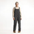Full body front view of model wearing organic cotton overalls in color pepper