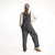 Full body back view of model wearing organic cotton overalls in color pepper
