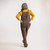 Full body back view of model wearing organic cotton overalls in color chocolate.