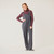 Full body front view of model wearing organic cotton overalls in color infinity blue.