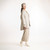 Full body side view of model wearing organic cotton workwear shirt in color pearl.