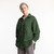 Front view of model wearing organic cotton workwear shirt in color pine.