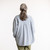 Back view of model wearing organic cotton workwear shirt in color denim blue.
