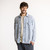 Front view of model wearing organic cotton workwear shirt in color denim blue.