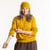 Model wearing organic cotton fisherman beanie in color gold